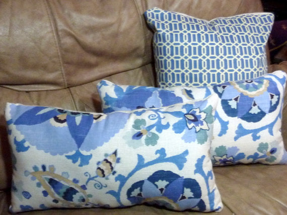 WHite and blue pillows accent a white linen couch placed in a